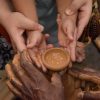 Woman and child hands shaping clay