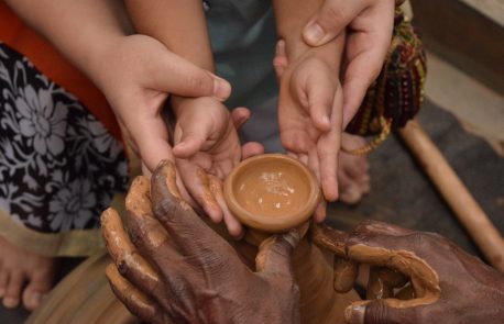 Woman and child hands shaping clay